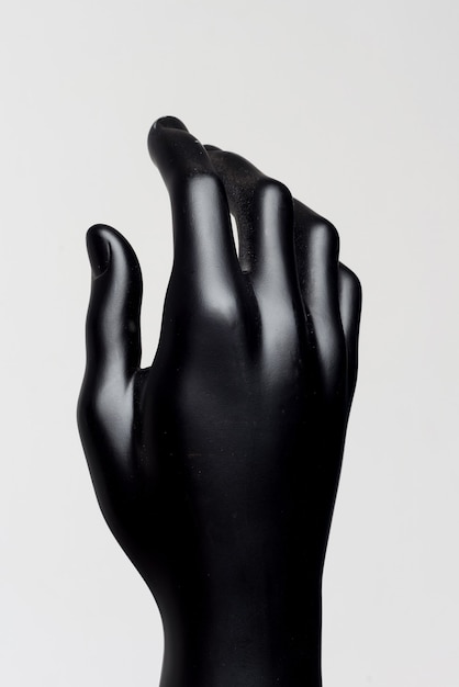 Hand of male black mannequin on a white