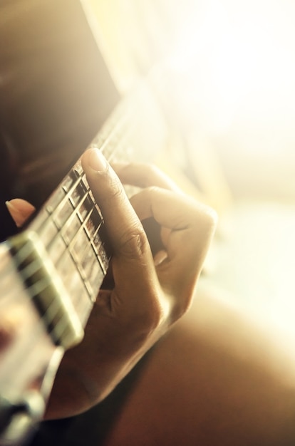 Photo hand of man in classical guitar