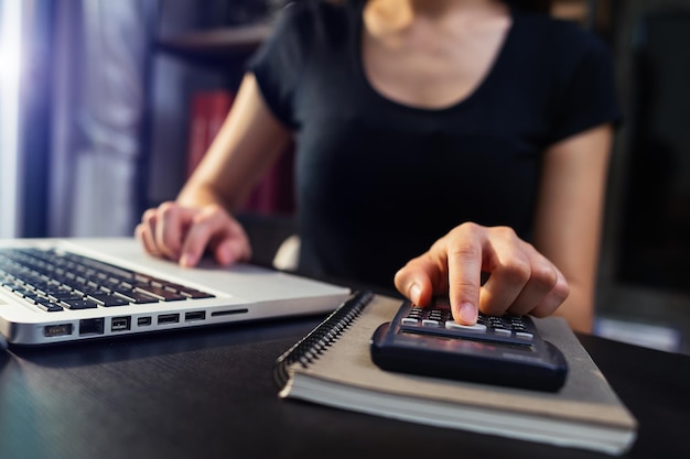 Hand man doing finances and on desk about cost at officexA