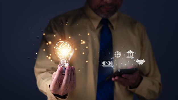 Hand of a man holding illuminated light bulb concept creativity with bulbs that shine glitter Inspiration of ideas for sustainable business development an Idea of innovation and inspiration concept