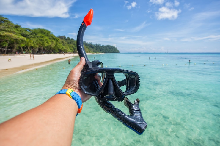Hand man holding snorkel goggles 