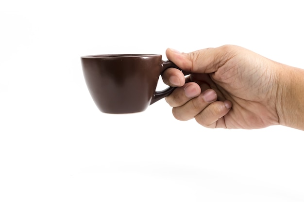 Hand of man is holding the brown ceramic coffee cup isolated