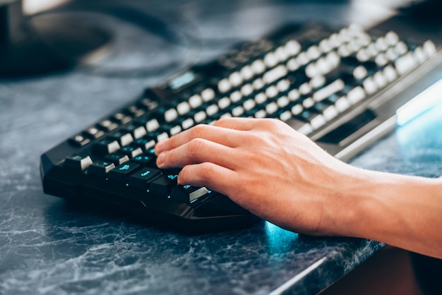 Hand man on the keyboard tinted The concept of computer technology and communication