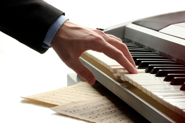 Hand of man playing piano