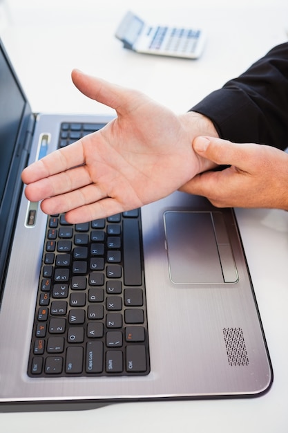 Hand of man touching his wrist