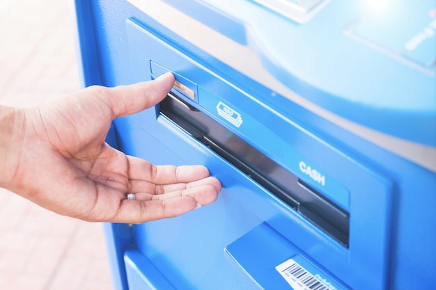 Hand of man using atm machine