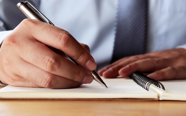 The hand of the man who wrote the concept book, signing the contract