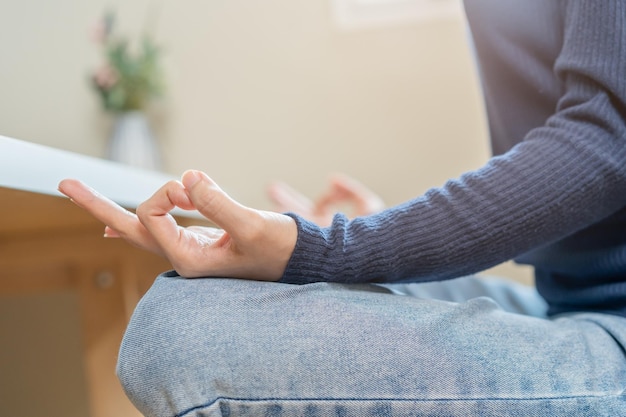 Hand of mental balance asian young woman girl practice sitting yoga in lotus position meditating calm pose for meditation exercise for wellbeing healthy care Relaxation leisure people lifestyle