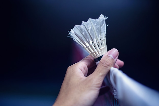 Hand met badminton over het net