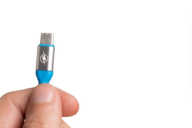 Hand met een blauwe USB C-kabel op een witte achtergrond.