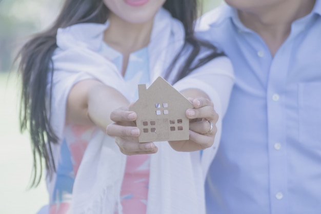 Hand met een houten huis