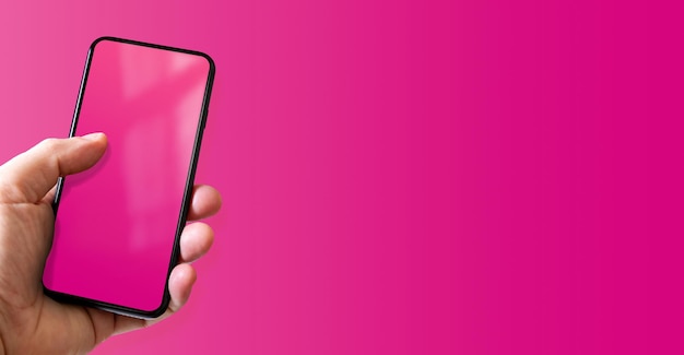 Hand met een smartphone met leeg roze scherm kleurrijke horizontale banner