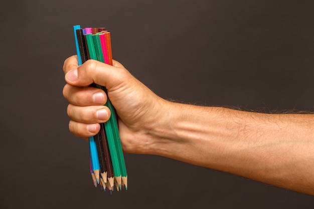 Hand met veelkleurige potloden