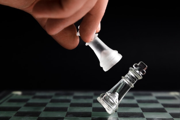 Hand moving transparent chess pieces