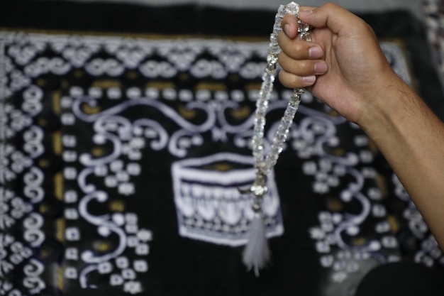 Hand of Muslim man praying with rosary in the mosque