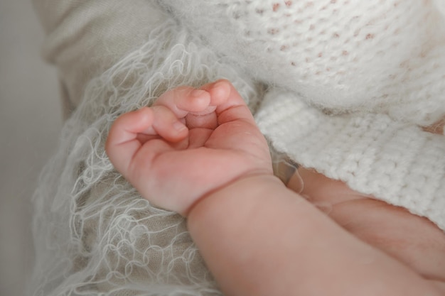 Hand of the newborn in a beautiful pose Closeup