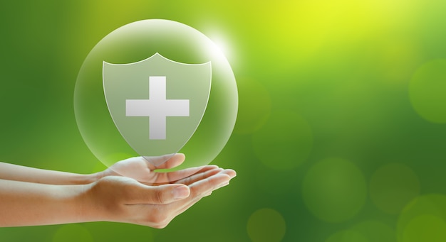 Photo hand offer medical shield on green background family life insurance medical care insurance