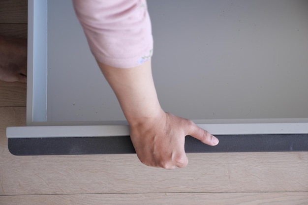 Hand open drawer wooden in cabinet