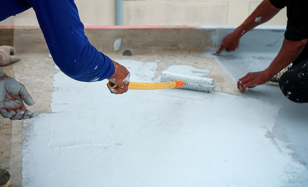 Hand painted gray flooring with paint rollers for waterproof reinforcing net