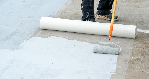 Hand painted gray flooring with paint rollers for waterproof reinforcing netRepairing waterproofin