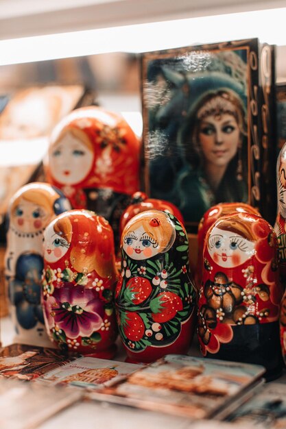 Photo hand painted russia wooden doll matryoshka females cartoon faces with red lipstick and rosy cheeks