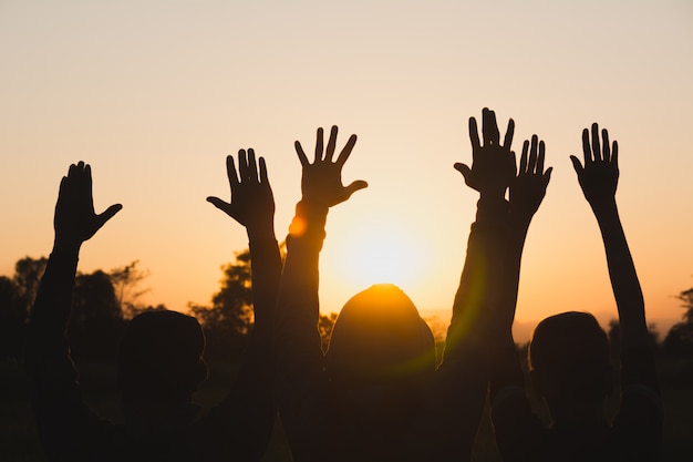 Hand of people arm raising up showing power strong with sky background.