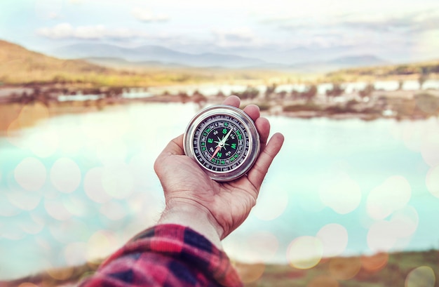 Hand of person holding compass