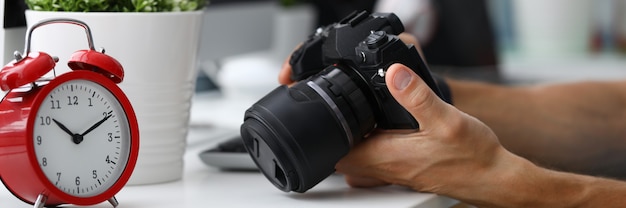 Hand photo camera office. Computer technology