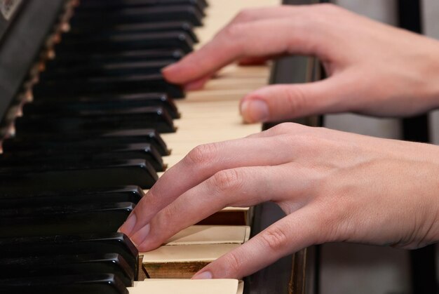 The hand on piano keyboard