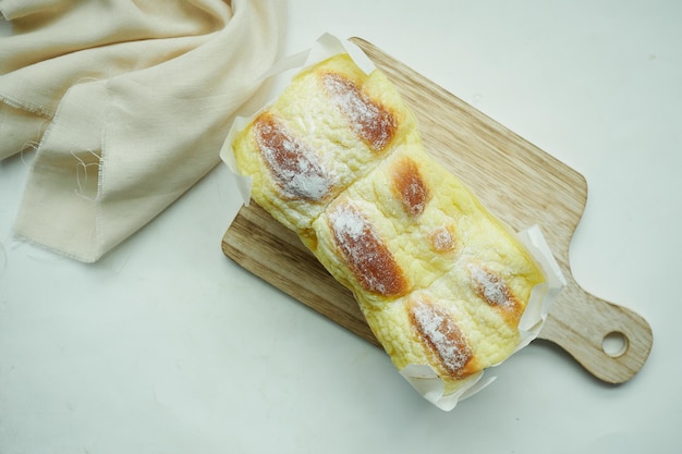 Hand pick a cream butter bread from a table
