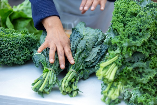 Hand picking chard from local market