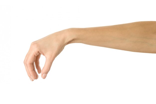 Raccogliere, tenere, afferrare o raggiungere a mano. gesturing della mano della donna isolato su bianco