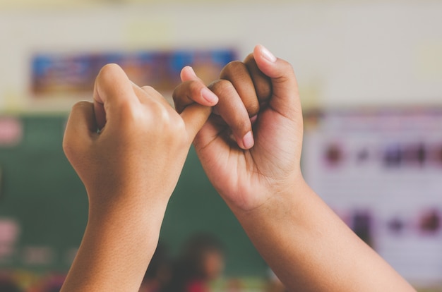 Photo hand to pinky swear, happy couple or friendship holding hands together forever love concept.