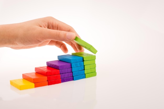 Hand playing with colored domino