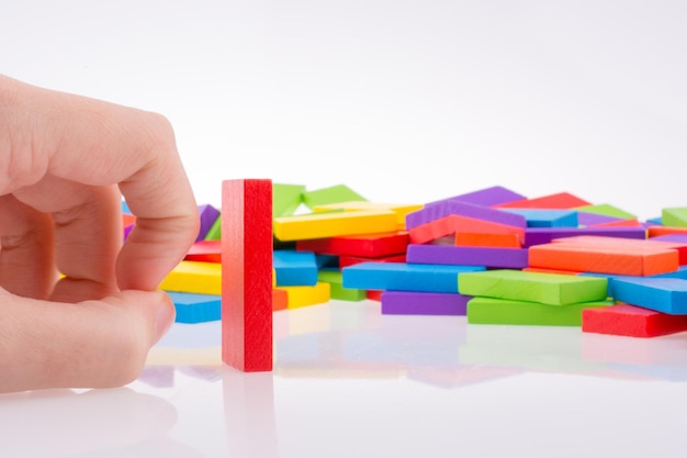 Hand playing with colored domino