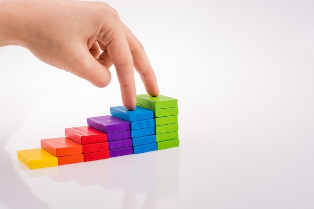 Hand playing with colored domino