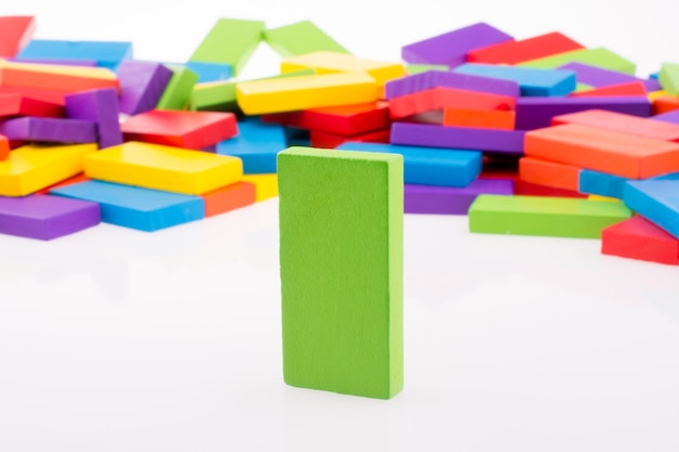 Foto mano che gioca con il domino colorato