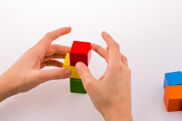 Hand playing with cubes