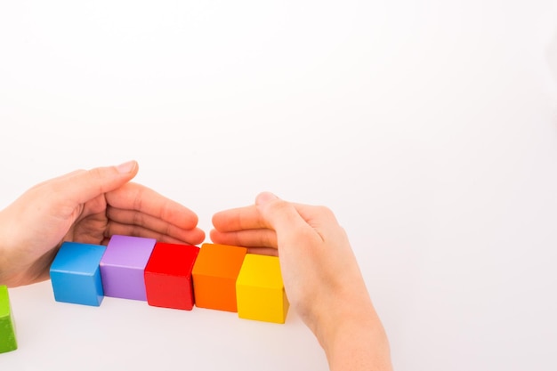 Hand playing with cubes