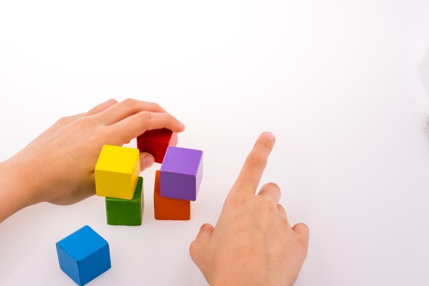 Hand playing with cubes