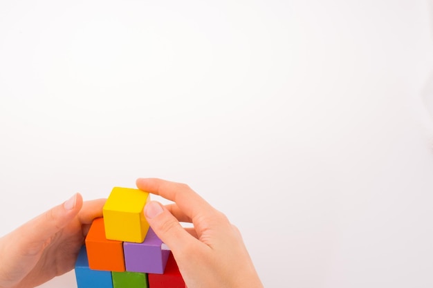 Hand playing with cubes