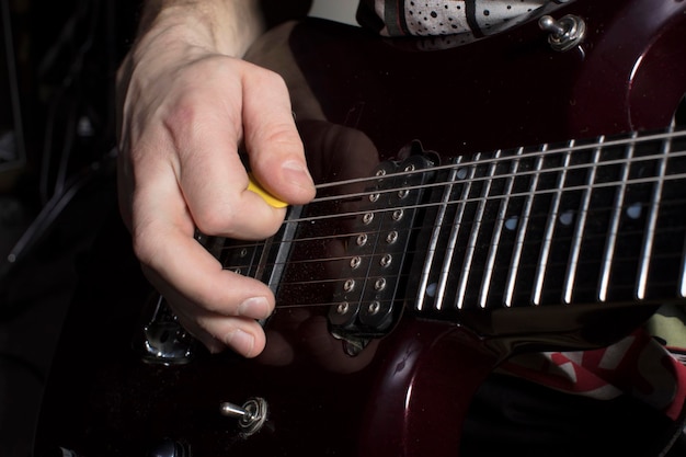 Hand plays the guitar Iterate over the strings