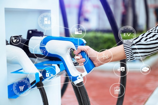 Hand plugging in a charger in an electric car socketElectric car or ev is charging at station with VR icon