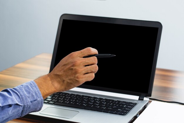 Hand pointing focus on computer in workspace office