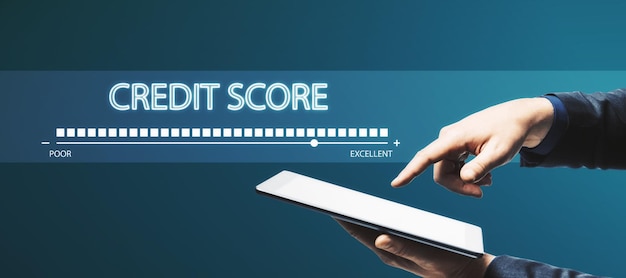 Photo hand pointing at tablet creative credit score bar on blue background financial performance and history concept