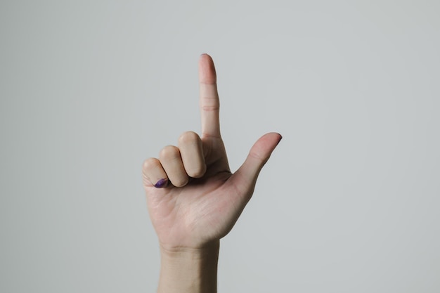 Photo a hand pointing up after pemilu or indonesian election day on white background