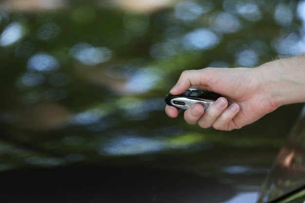 Hand presses on remote control car alarm systems