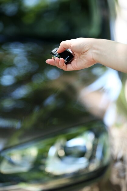 Photo hand presses on remote control car alarm systems