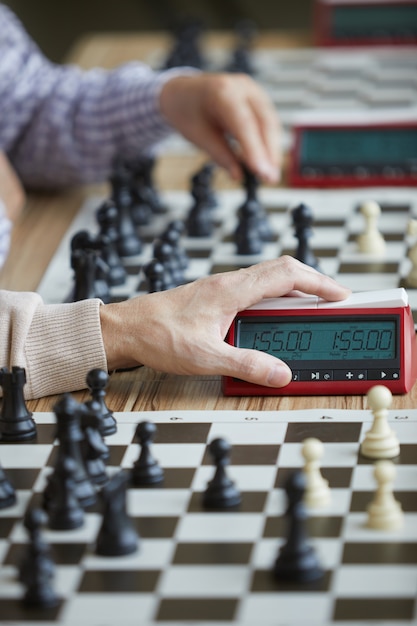 Hand pressing chess clock