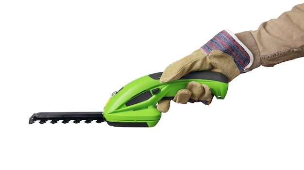 Hand in protective glove holds handheld electric garden trimmer